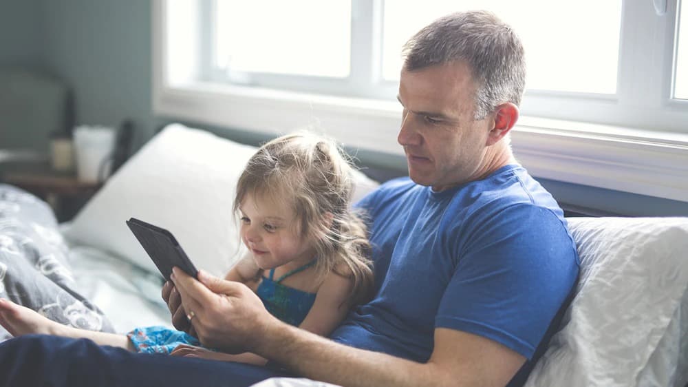 father-and-daughter-share-tablet