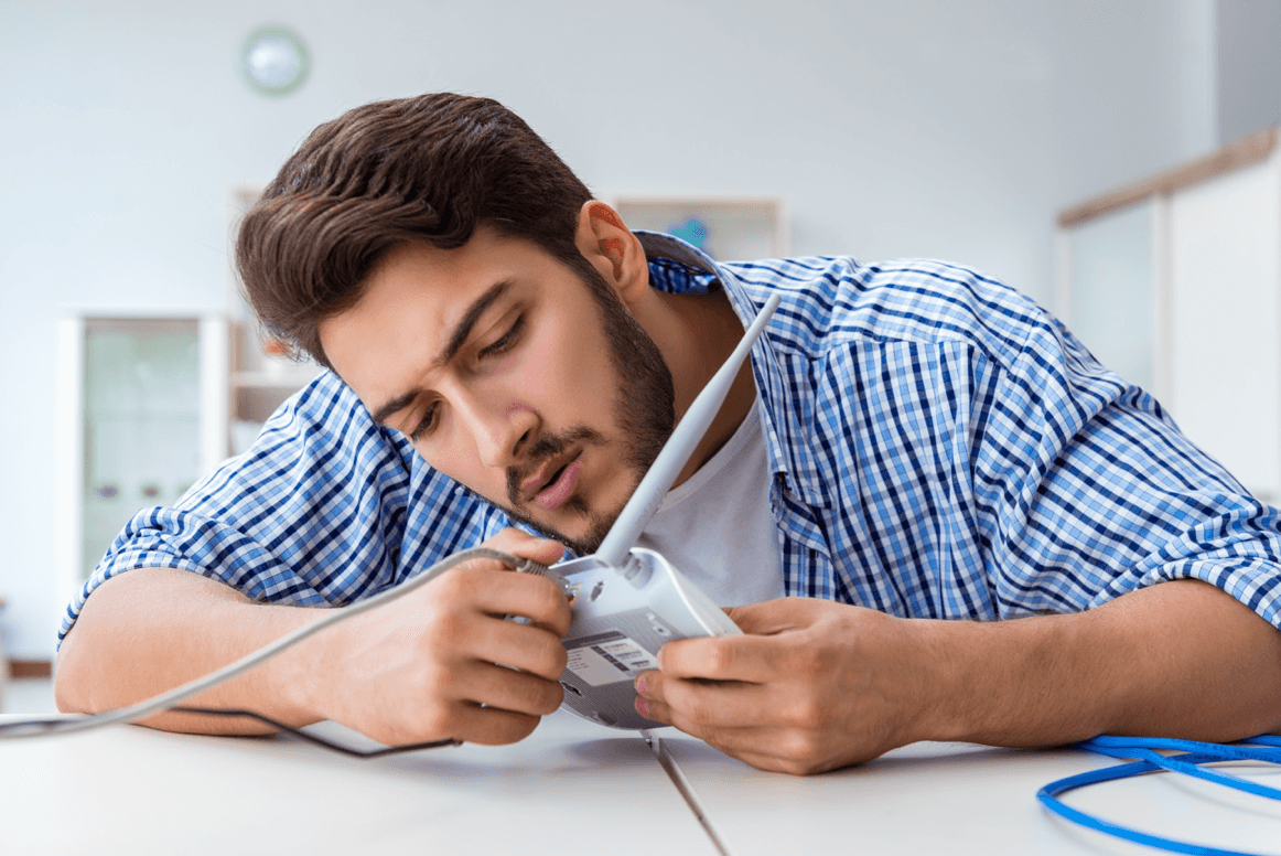 Man pulls power cord from internet router
