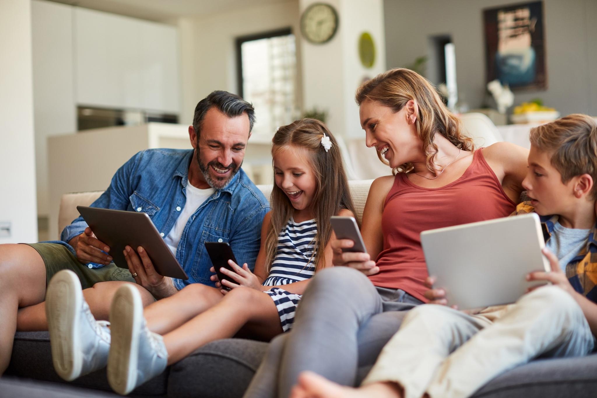 Family on several tablets and smartphones connected to gigabit internet