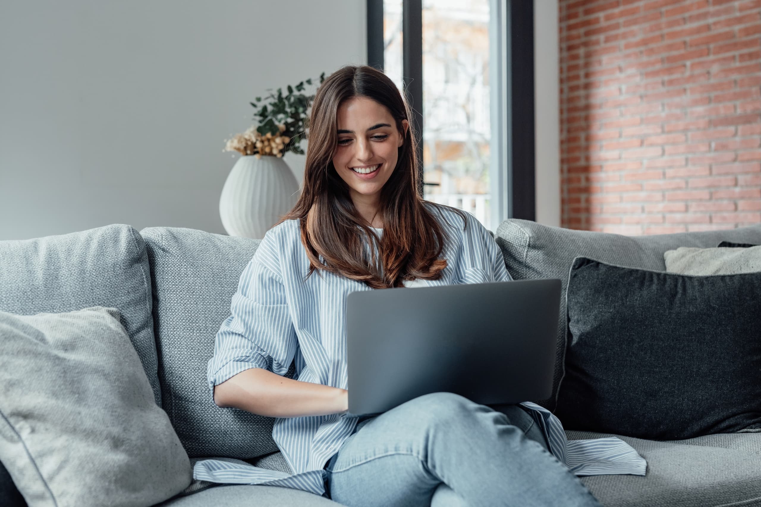 blog/A person sitting on a couch, using a computer