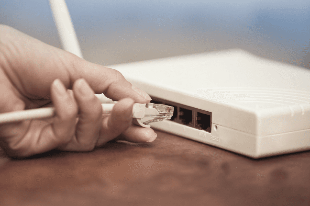 Hand plugging in ISDN cable to router