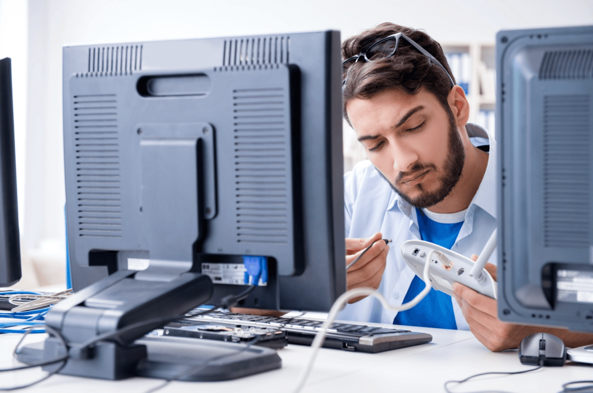 Man inspects wire port in modem
