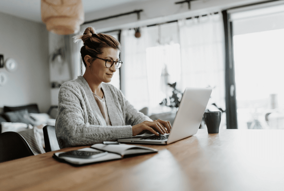 Woman checks email on laptop computer