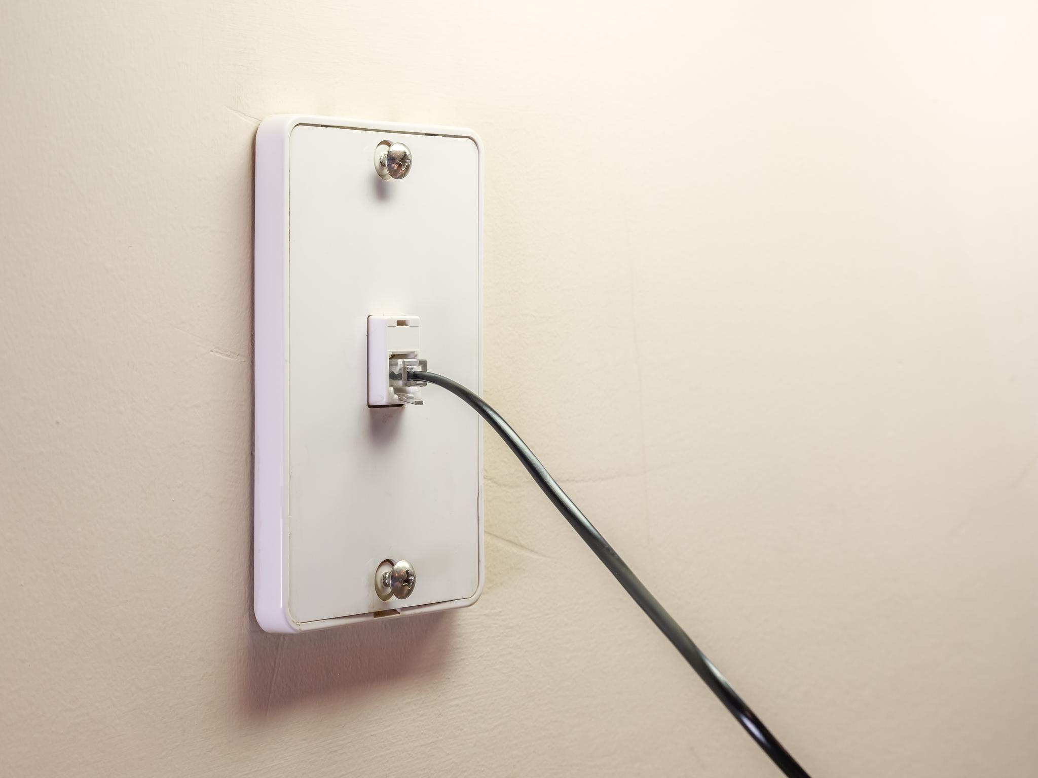 DSL cable plugged into a wall socket