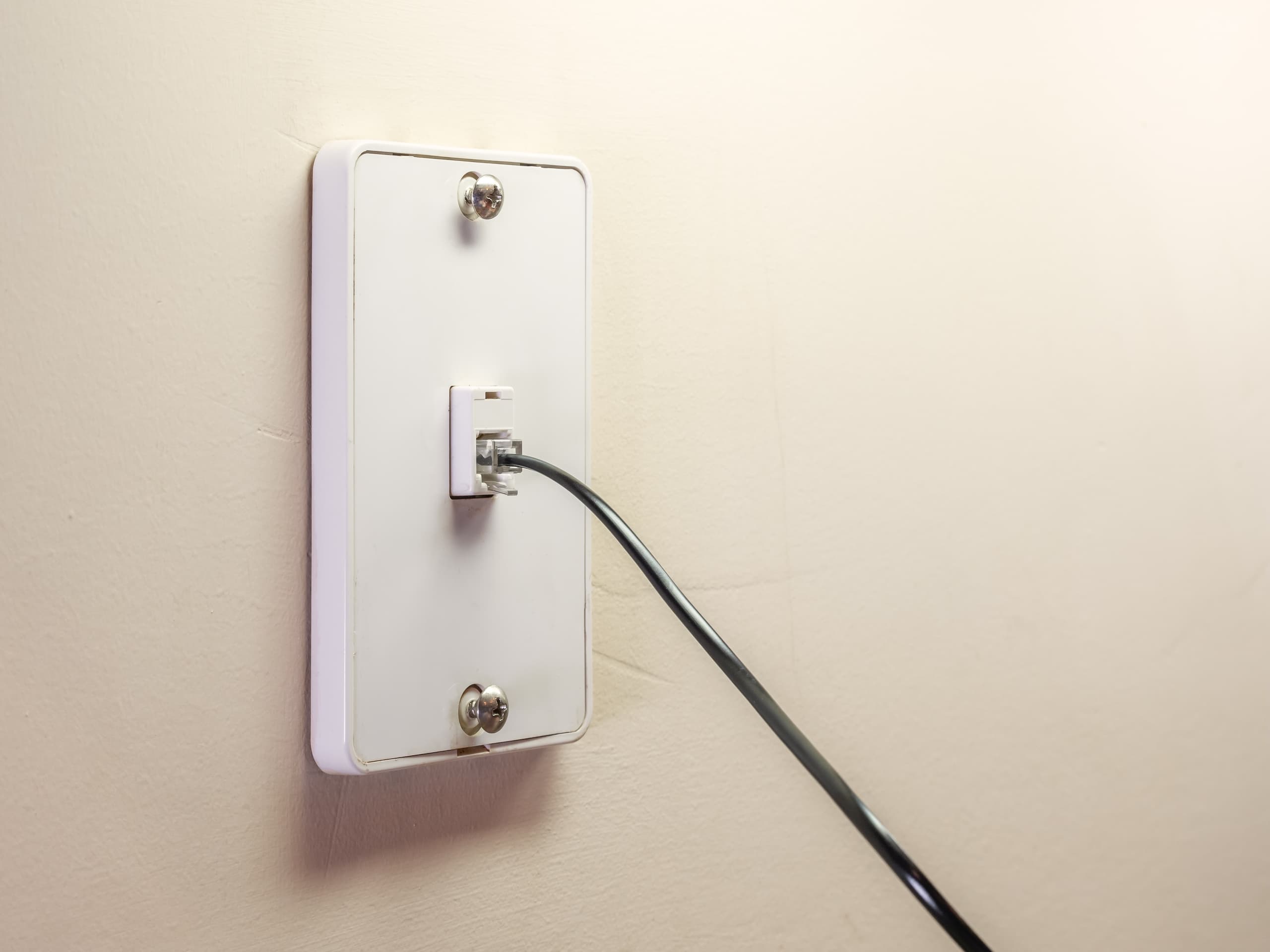 blog/DSL cable plugged into a wall socket