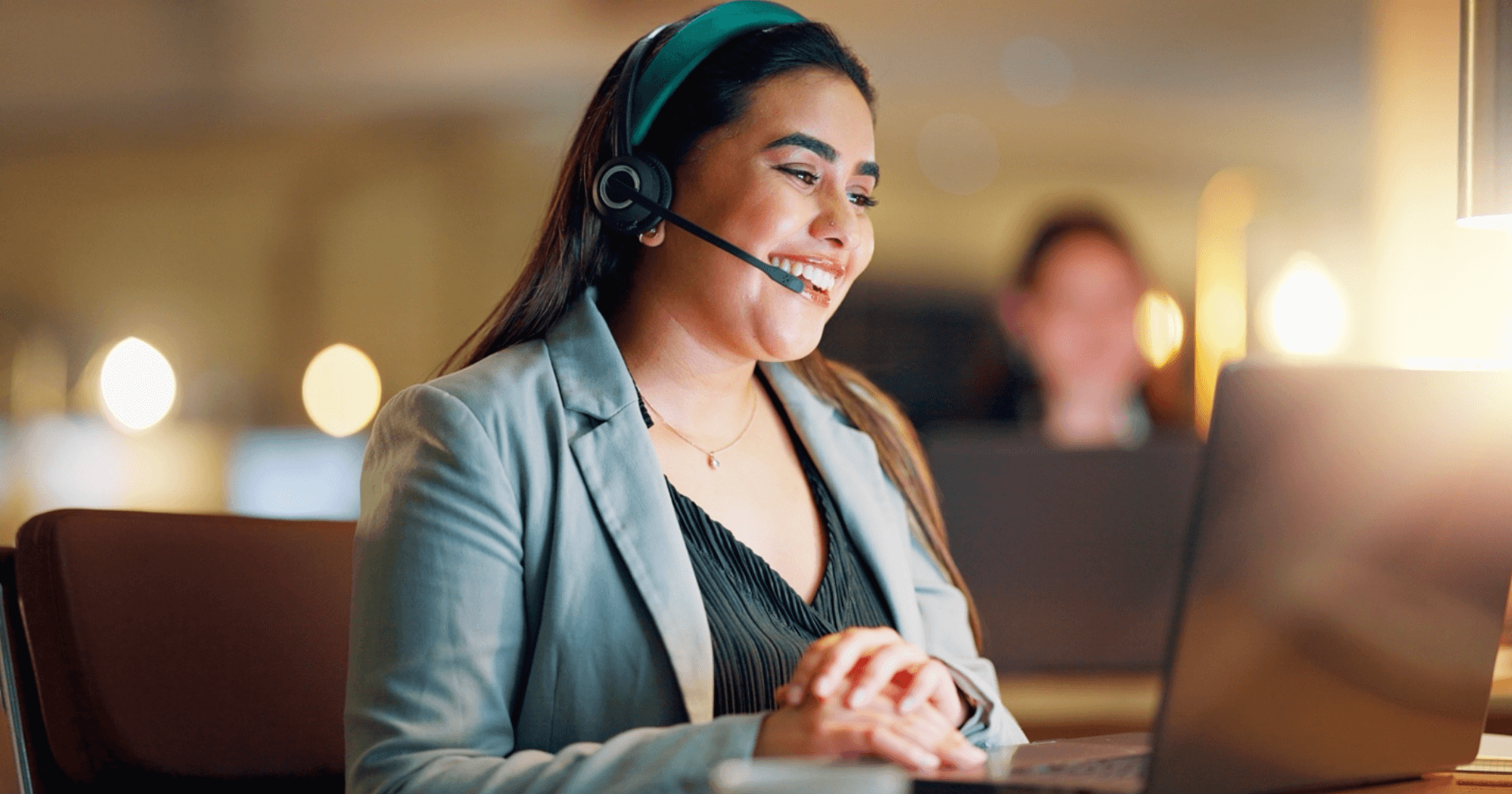 Smiling customer support agent in a call center