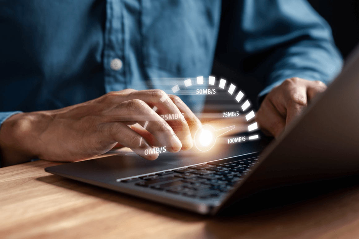 Speedometer measures internet speed on top of a laptop keyboard