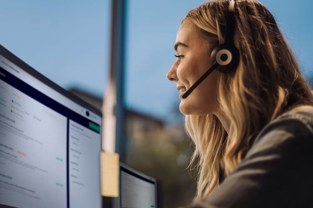 Young woman handling online customer service wearing headset