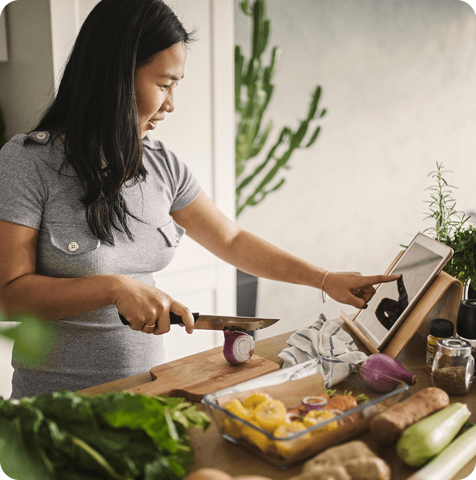 cards/woman-cooking-and-looking-at-recipe-on-ipad
