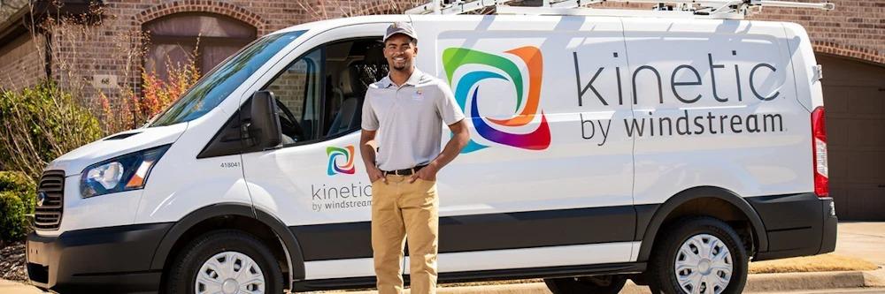Kinetic technician stands in front of Kinetic service truck