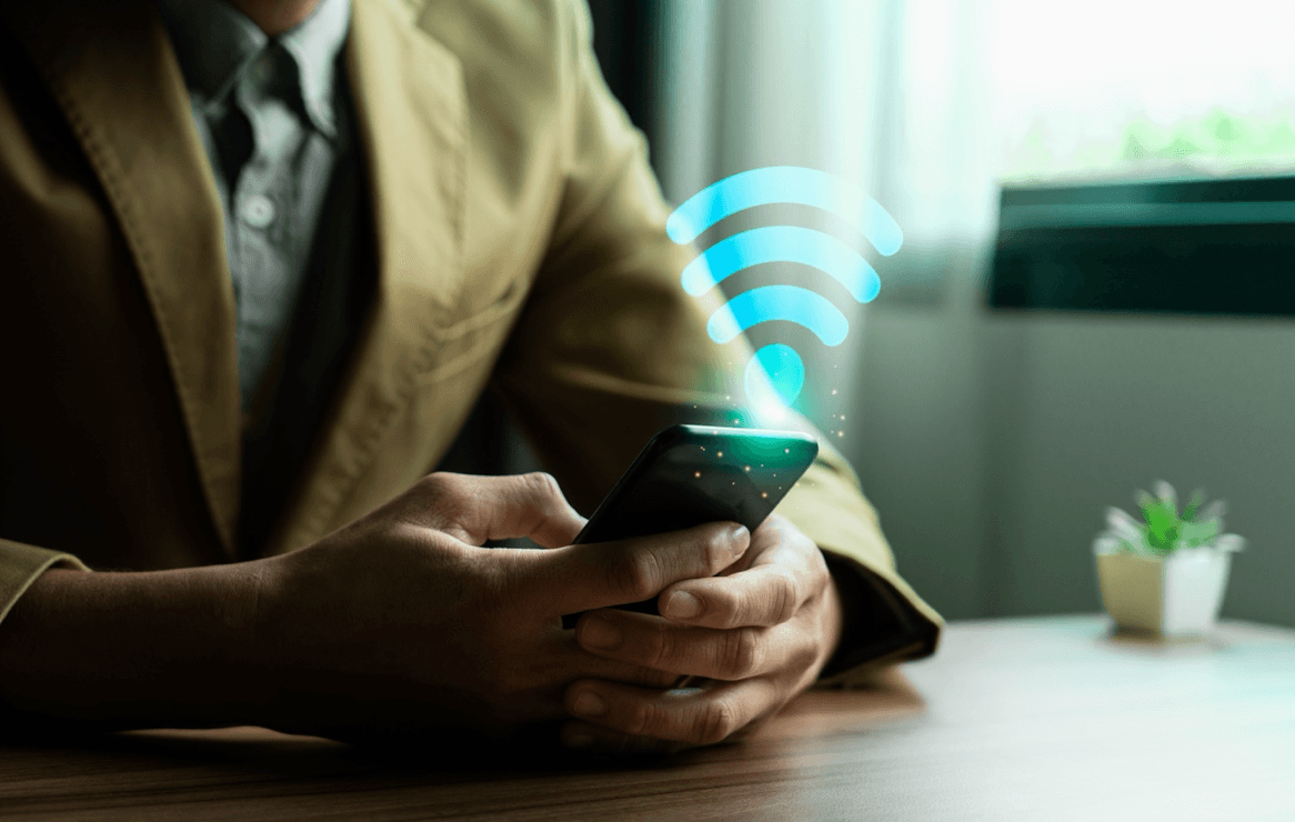blog/Man holds phone with Wi-Fi signal floating above it.png