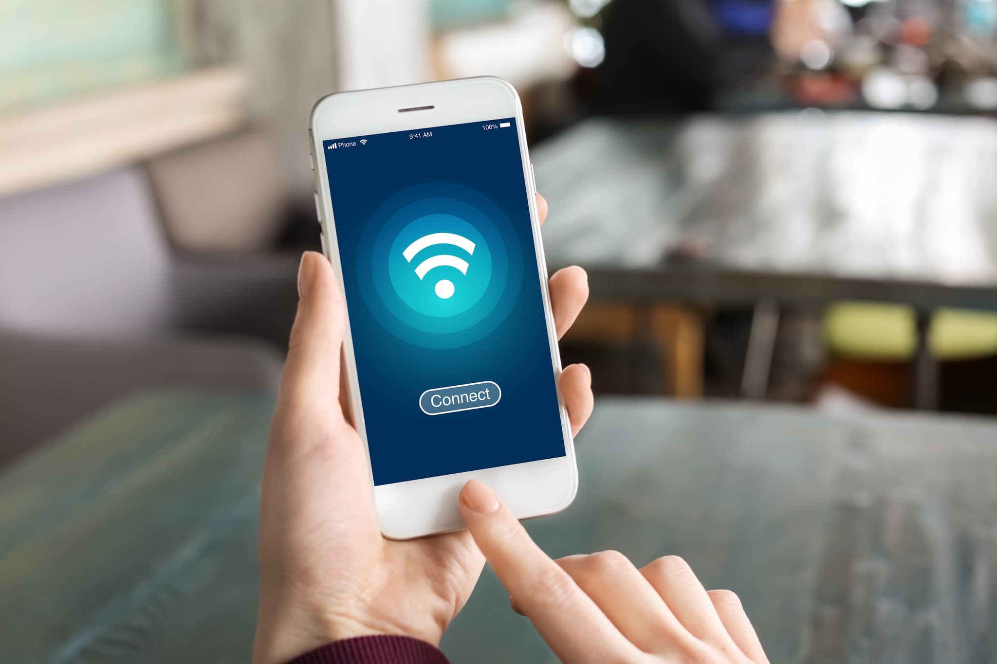 Hand holds a smart phone with Wi-Fi icon and “Connect” button