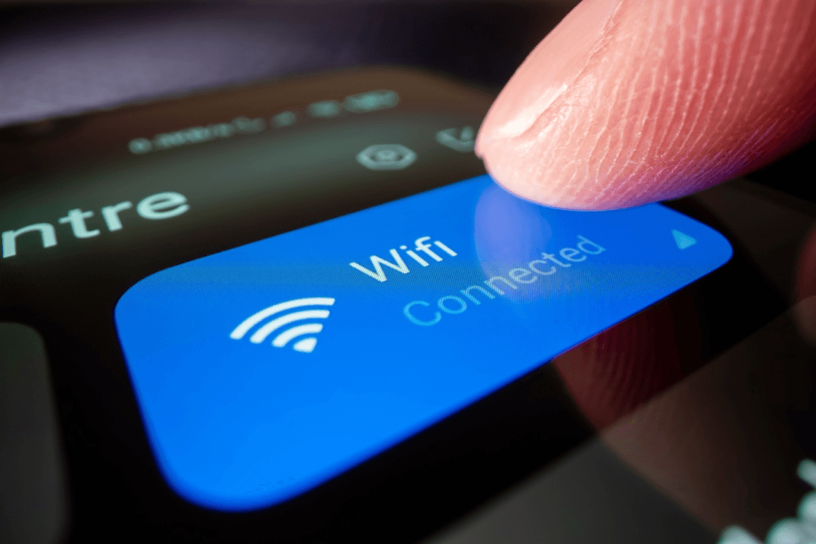 blog/Close-up of finger tapping Wi-Fi connection button