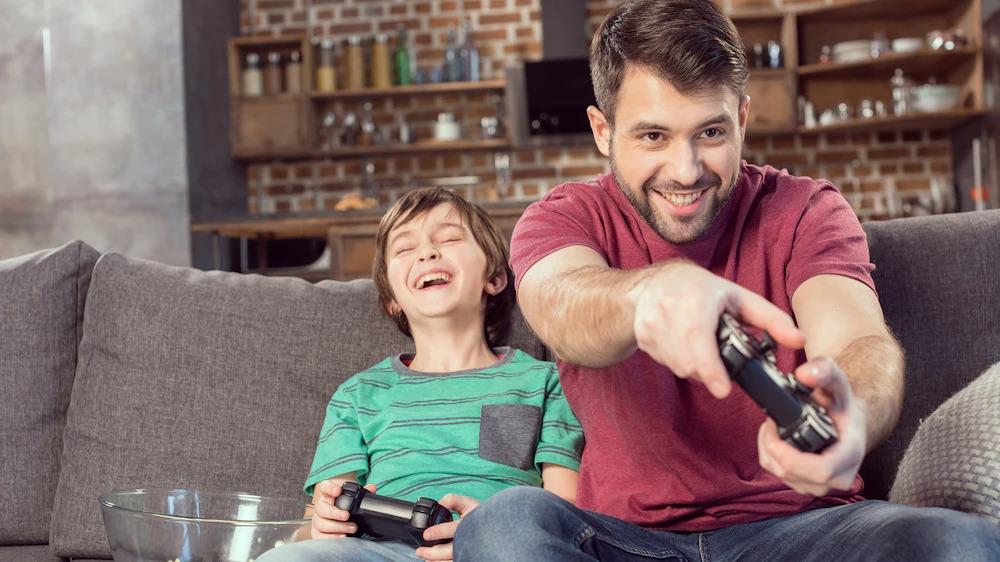 Parent and child enjoy video gaming together