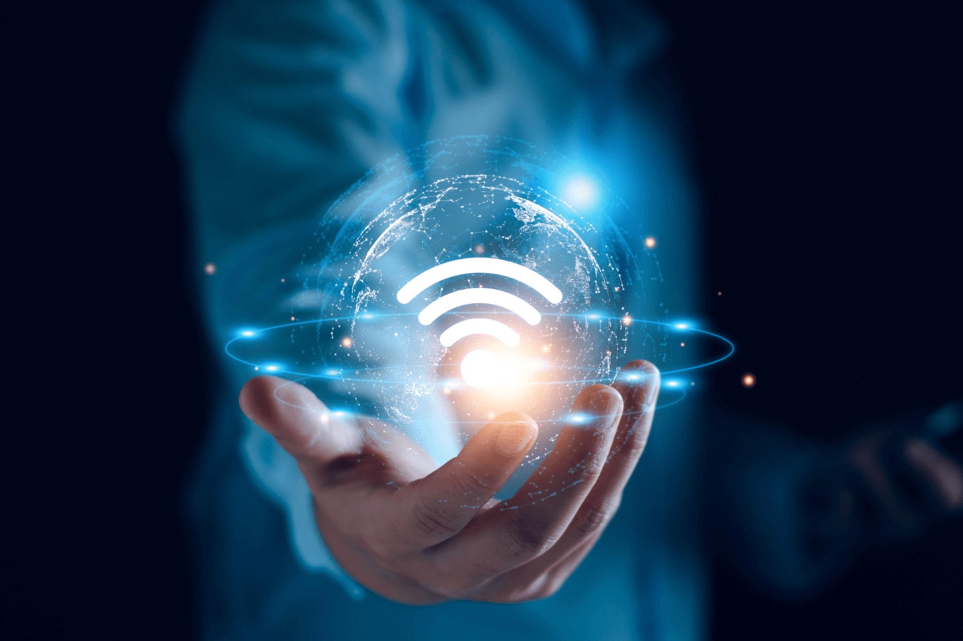 Hand holding a glowing 3-D illustration of a Wi-Fi symbol inside of a planet
