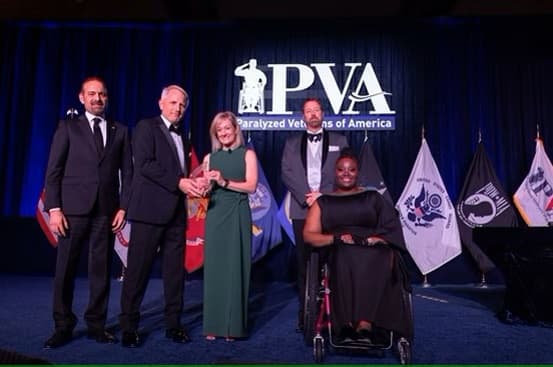 Windstream receives PVA 2024 award on stage with dressed up group