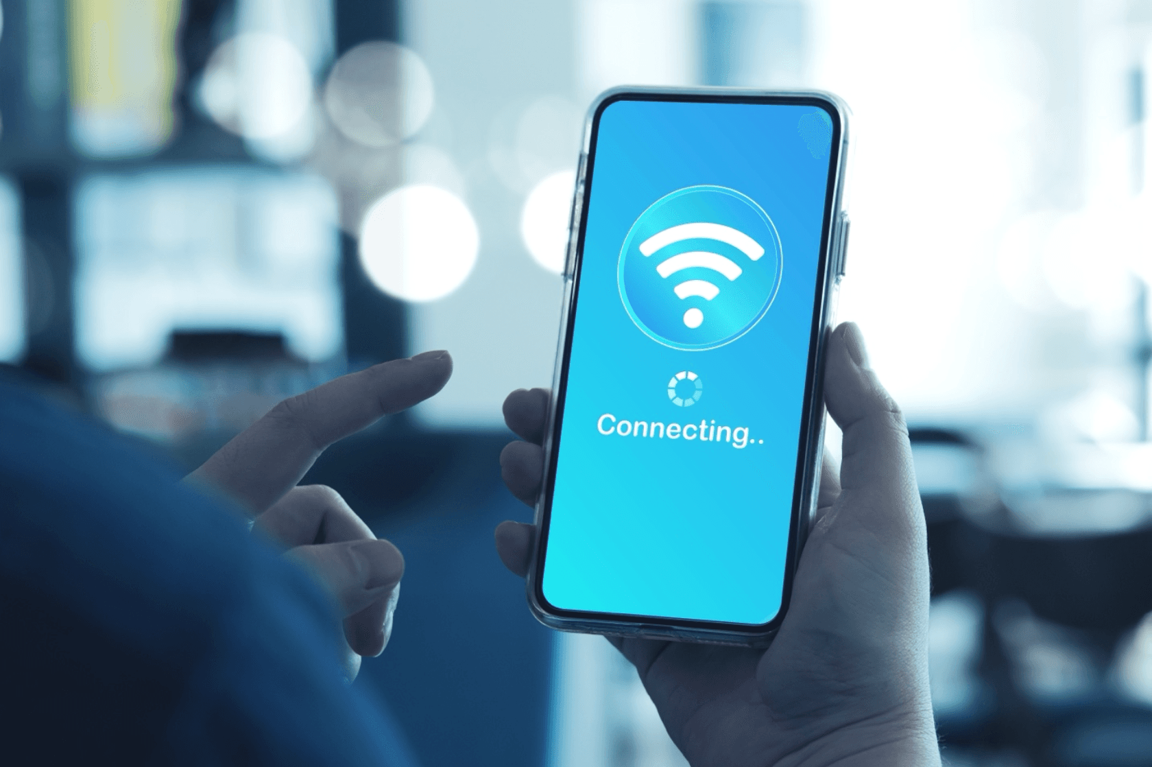 Person holding a smartphone with a Wi-Fi symbol about the word “Connecting…”