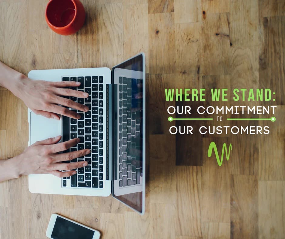 Image of laptop from above with hands on keyboard and the headline, "Where we stand, our commitment to our customers"