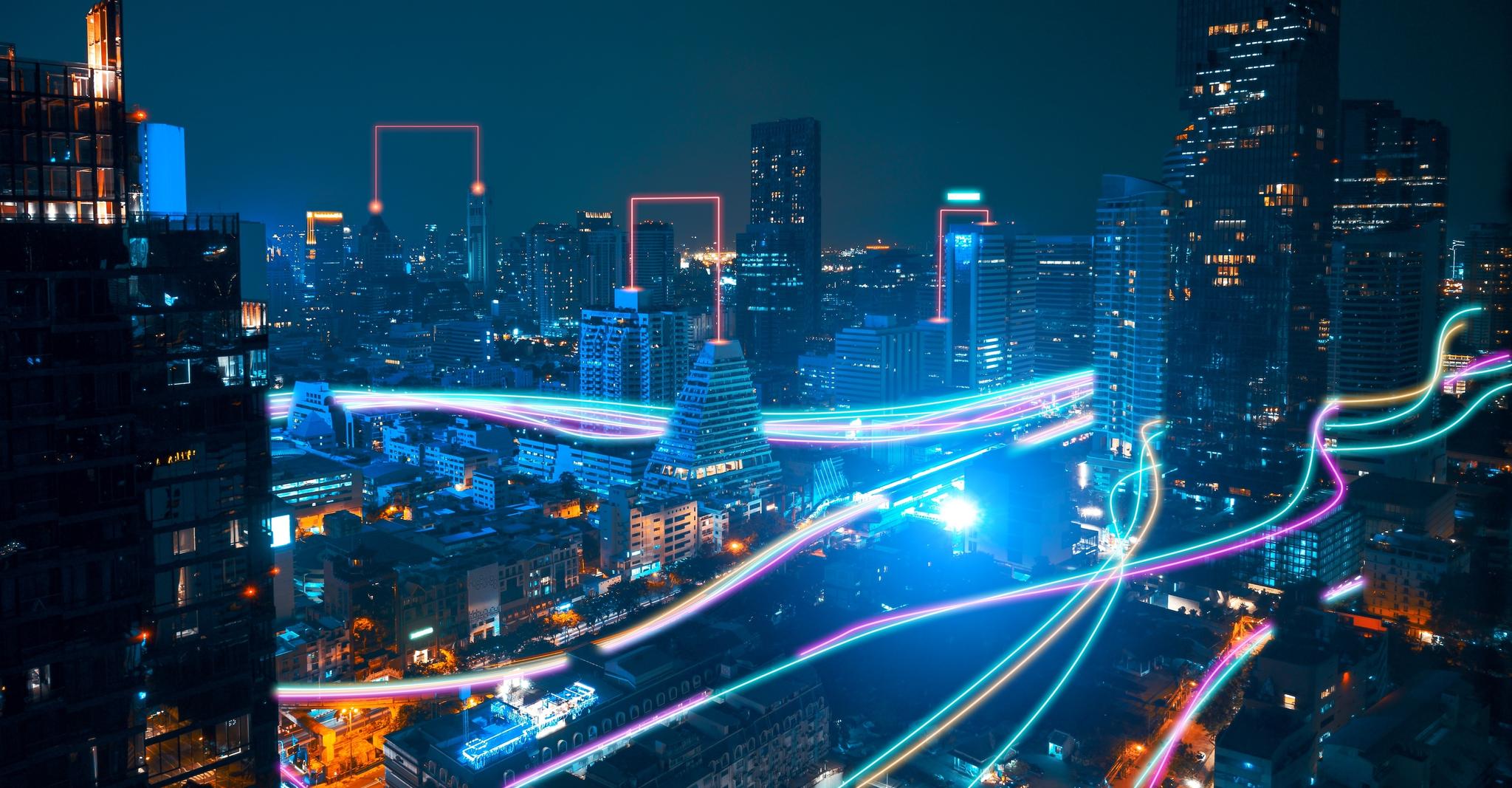 Fiber internet light streams move through a futuristic cityscape