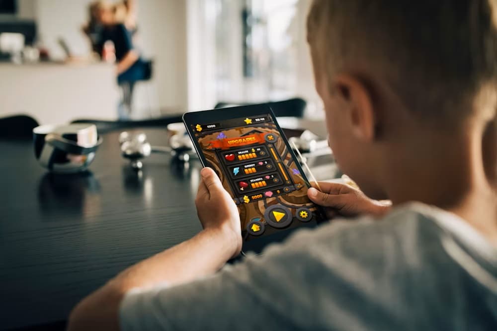 Young Boy Playing Video Game on Tablet