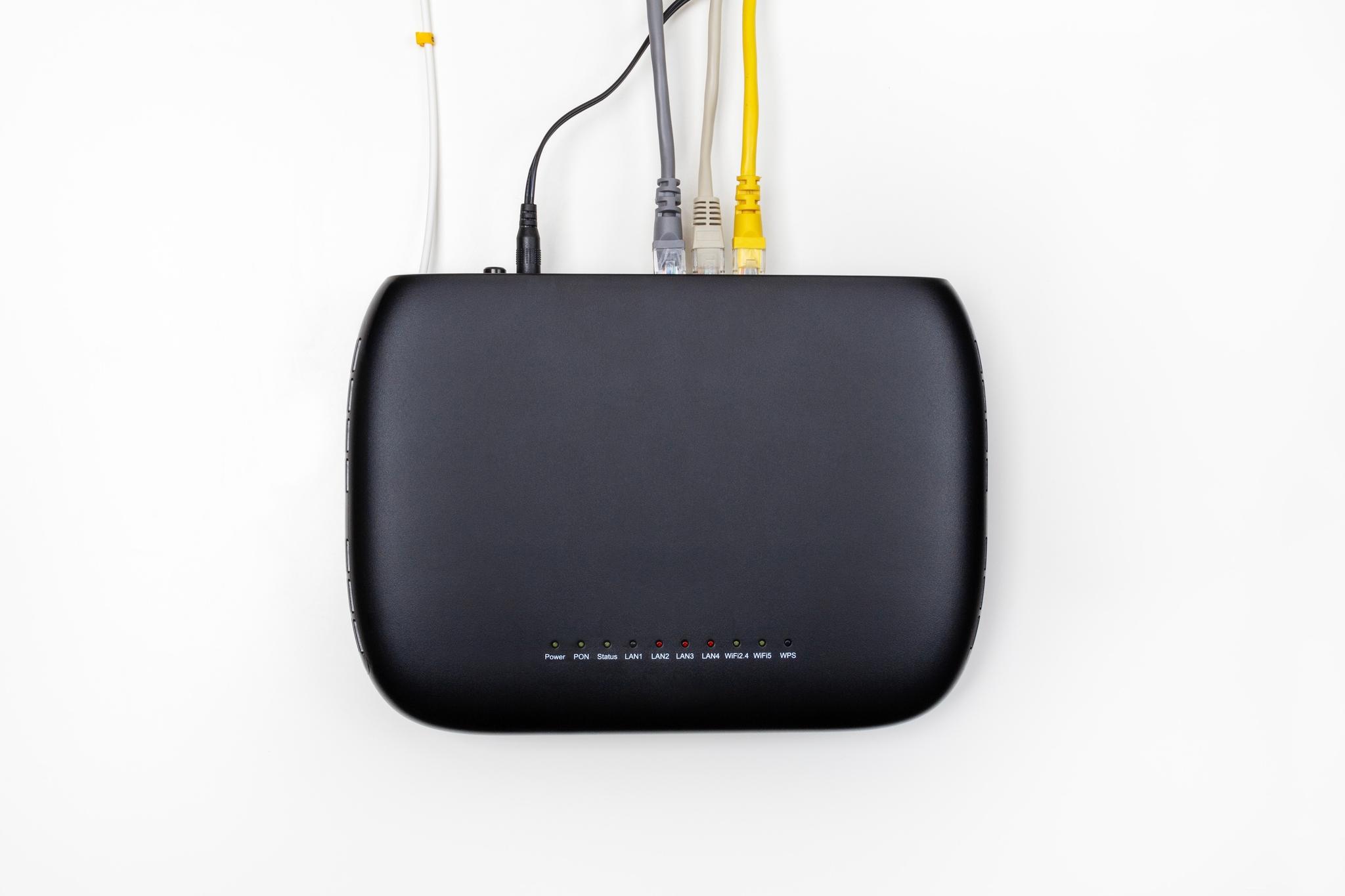 Black optical network terminal with cables plugged into it