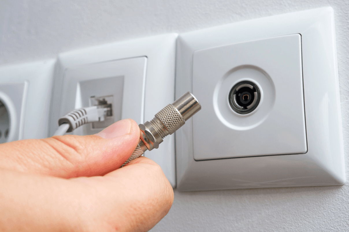 blog/Hand holding coaxial cable near port.png
