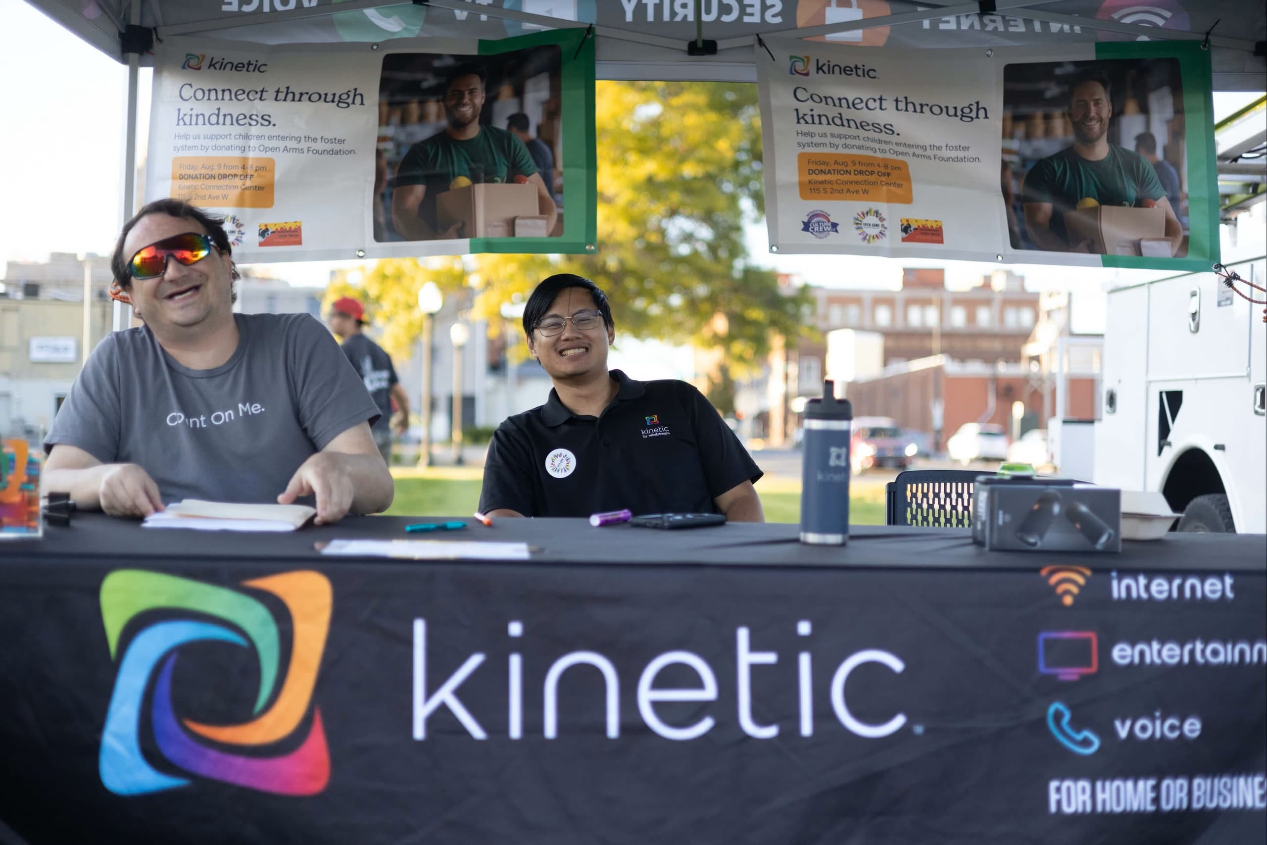 Two local Kinetic representatives working event table